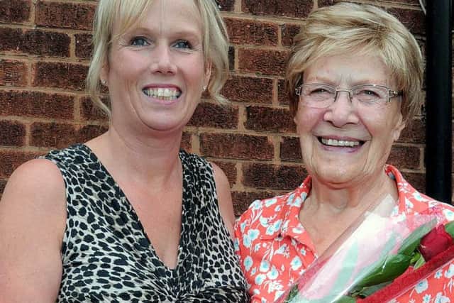 Joyce Malbon receiving her Guardian Rose from Neighbour Carol Chambers
