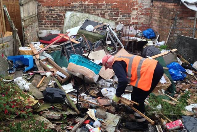 West Lindsey staff start the clean up of rubbish at a High Street property.