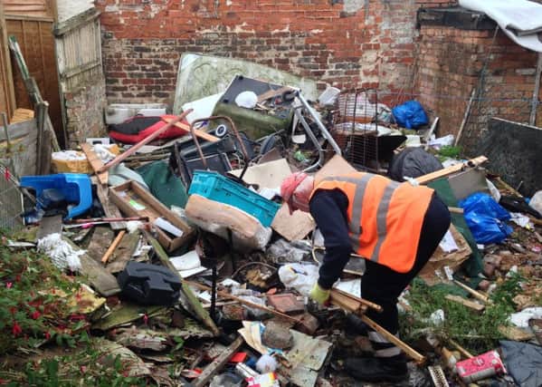 West Lindsey staff start the clean up of rubbish at a High Street property.