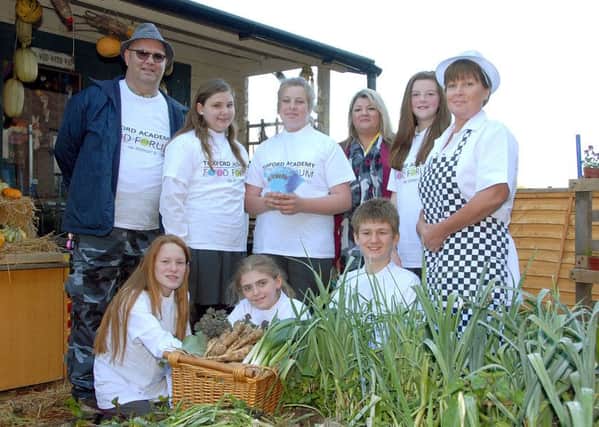 Pupils and staff at Tuxford Academy with the garden vouchers given to the school in exchange for produce grown for the school kitchen.  Pictured from the left are (back row): Alan Hardy (school gardener), Lydia Battersby, Ashley Hope, Kathryn Daly, Nicola Coverley; (are catering manager at Nottinghamshire County Council),  Alison Harvey (school catering manager). Front: Lucy Marshall, Amelia Fletcher and Claude Wallace. Picture: Roger Grayson