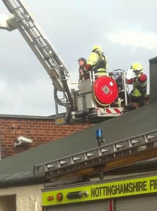 The scene on Vine Terrace in Hucknall when a woman was stuck on the roof of Spot On snooker venue