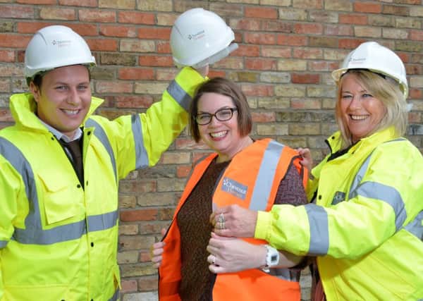 Chestnut Homes Director Robert Newton and Sales and Marketing Manager Barbara Goodwin (left and right) show how visitors will be kitted up in hard hats and high-vis vests at the event