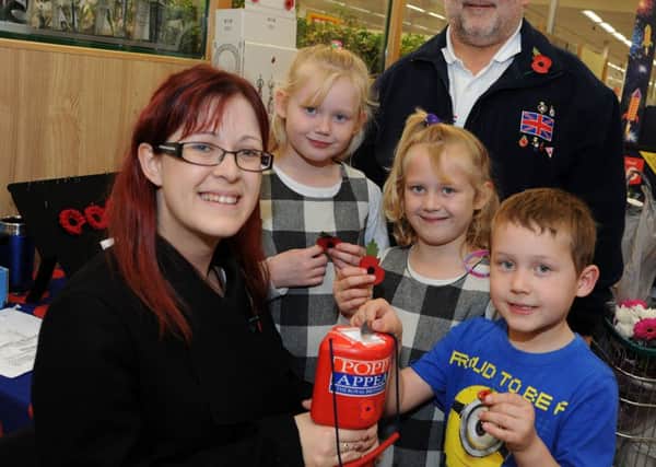 Gainsborough Standard reporter, Shelley Marriott with Dave Freestone from the Gainsborough RBL and Leo, Caitlin and Caisey Greaves who bought their poppies at the town's Morrison's store.