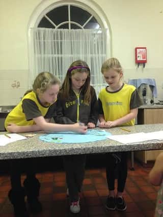 Members of 1st Shireoaks (St Luke's) Brownies creating their spot for Blue Peter's superhero cape world record challenge