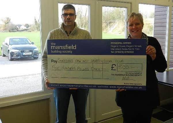 Brian Seddons, from The Mansfield, presents the cheque to Rachel Barrowcliffe from Shireoak Sports & Social