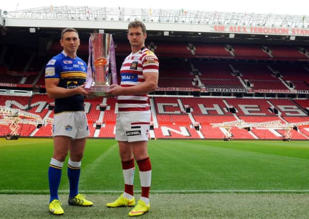 Leeds Rhinos captain Kevin Sinfield, left, and Wigan Warriors captain Sean O'Loughlin, holding the Super League trophy ahead of the 2015 Grand Final.