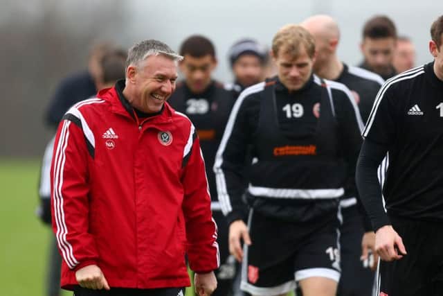 Nigel Adkins shares a joke with his squad during training Â©2016 Sport Image all rights reserved