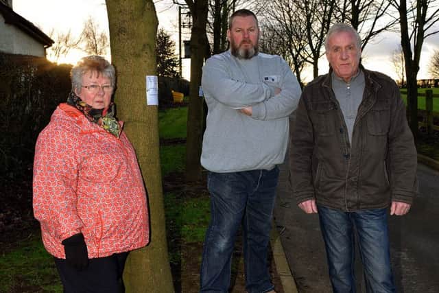 Residents are angry that the council want to remove memorial trees at Clowne Cemetery, Ross Walker is pictured centre with the tree dedicated to his Grandfather with his Mother Mary Walker and Uncle Keith Taylor