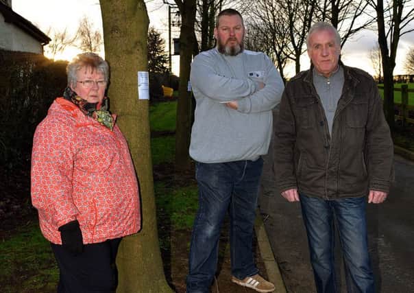 Residents are angry that the council want to remove memorial trees at Clowne Cemetery, Ross Walker is pictured centre with the tree dedicated to his Grandfather with his Mother Mary Walker and Uncle Keith Taylor