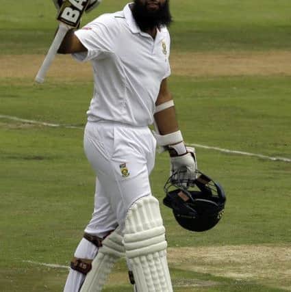 South Africas batsman Hashim Amla, raises his bat after scoring a century