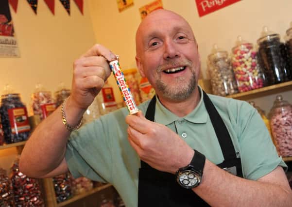 Dave Edwards of Edwards Emporium with a tube of lovehearts.