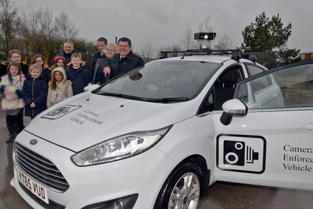 New road safety car equipped with CCTV to be rolled out at Nottinghamshire Schools, pictured are members of Redlands School road safety team with Coun Kevin Greaves, Paula Argyle and Gareth Johnson of Notts County Council Enforcement Team and Roger Holland