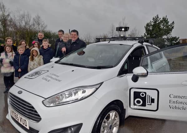 New road safety car equipped with CCTV to be rolled out at Nottinghamshire Schools, pictured are members of Redlands School road safety team with Coun Kevin Greaves, Paula Argyle and Gareth Johnson of Notts County Council Enforcement Team and Roger Holland
