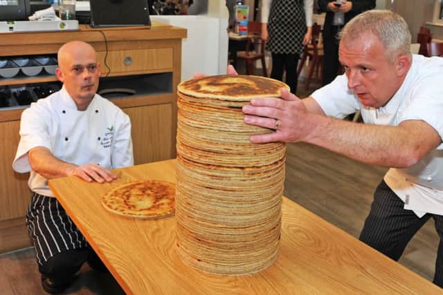 Centre Parcs Pancake House, World Record attempt.Group Executive chef, James Haywood, right and executive sous chef, Dave Nicholls build up the pancake stack.