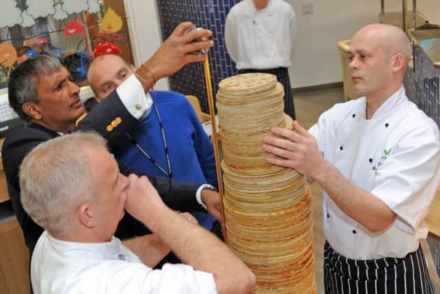 Centre Parcs Pancake House, World Record attempt.
Group Executive chef, James Haywood, and executive sous chef, Dave Nicholls have a nervous wait as adjudicator, Pravin Patel, from the Guiness Book of World Records, measures the assembled stack.