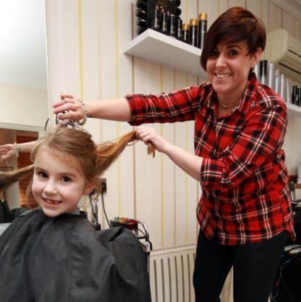 Maisie Priestley, six, had her hair cut for the Little Princess Trust. Maisie is pictured with Sarah-Jayne Heath from Roscoe's in Worksop.