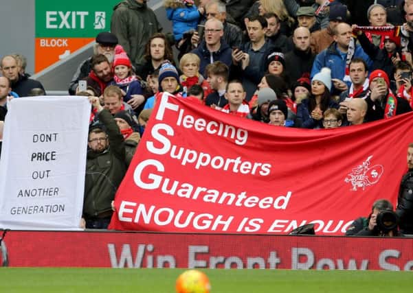 Fans held up banners protesting against ticket prices at Anfield on Saturday