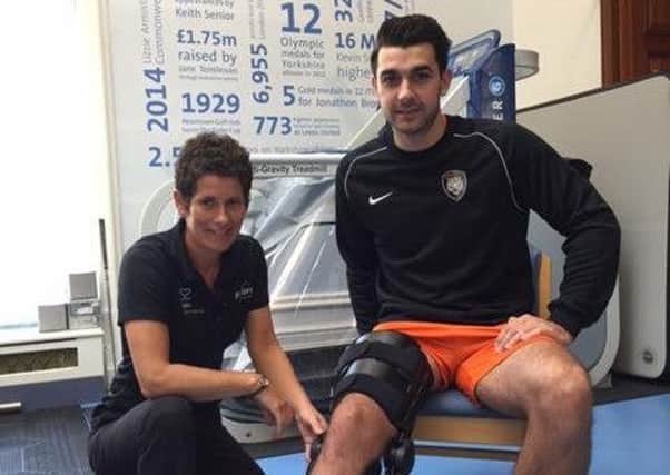 Sam Liversidge wearing the special knee brace, with Nicola Francis from the Perform Leeds team at Spire Leeds Hospital