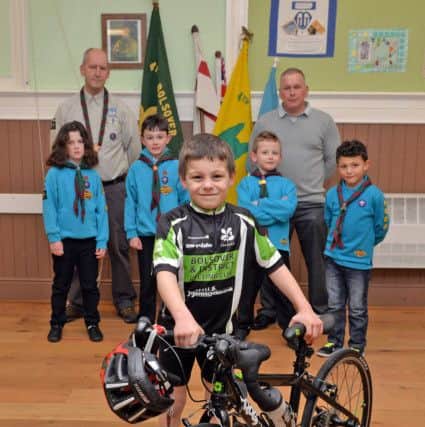 Seven year old  Ethan Ellam is taking part in a 30 mile sponsored bike ride to raise money for a new scout hut for the 4th Bolsover Scouts, Ethan is pictured with Scout leader Shane Taylor and Dad Stephen Ellam
