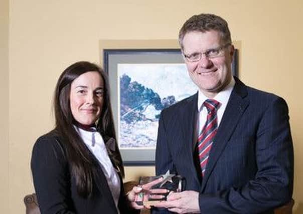 Melissa Brown receiving the Accountant of the Year award from Vertu Motors CEO, Robert Forrester. Picture: Neil Denham
