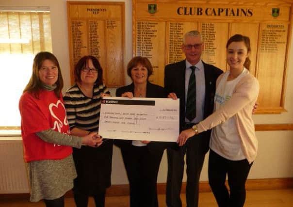 Retford Golf Club captains Angie Dyer (centre) and Neil Martindale presented fund raising cheques to (from left) Helena Mair, Brenda Hudson (British Heart Foundation) and Danielle Hindle (Altzeimers Society)