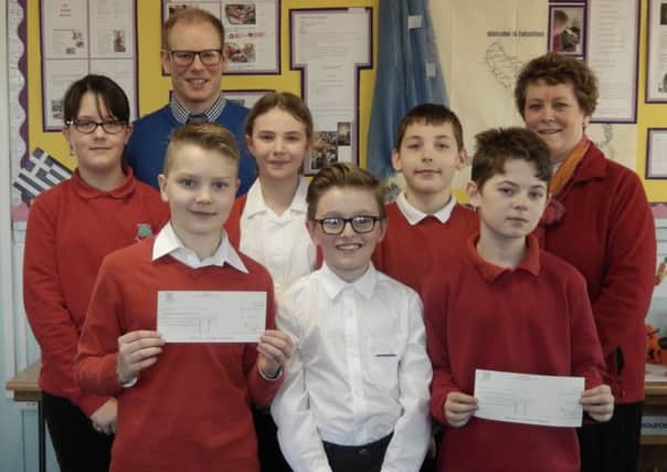 Coun Hazel Brand presents cheques to pupils at Misterton Primary School for them to take part in DARE