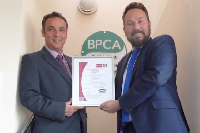 Mick Kilburn, managing director of EPM Ltd, receives the certificate of accreditation from Simon Forrester, chief executive of the British Pest Control Association.