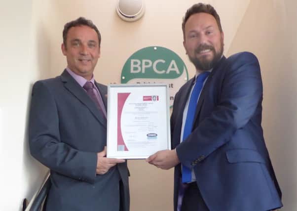 Mick Kilburn, managing director of EPM Ltd, receives the certificate of accreditation from Simon Forrester, chief executive of the British Pest Control Association.