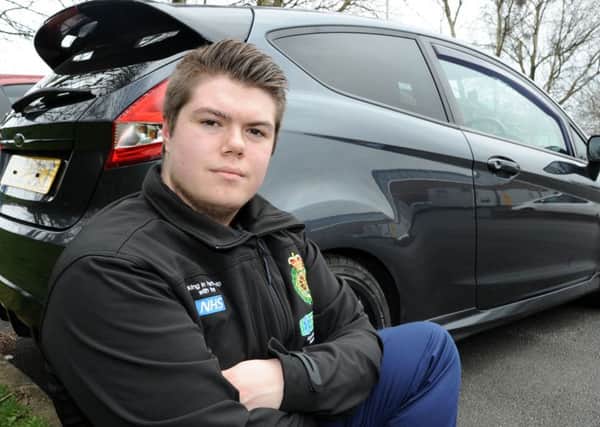 Scott Rathbone with his car that was vandalised.