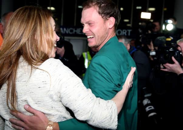 Danny Willett (right) arrives at Manchester Airport after his victory at The Masters in Augusta on Sunday