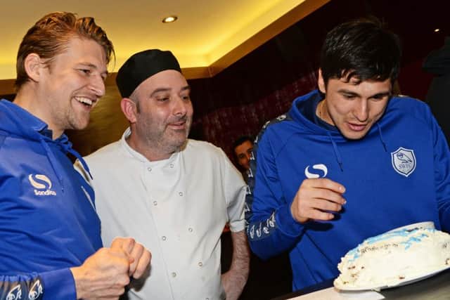 Sheffield Wednesday footballers Glenn Loovens and Fernando Forestieri decorate their cake, while Sous Chef Lee Crookes watches on. Picture: Marie Caley