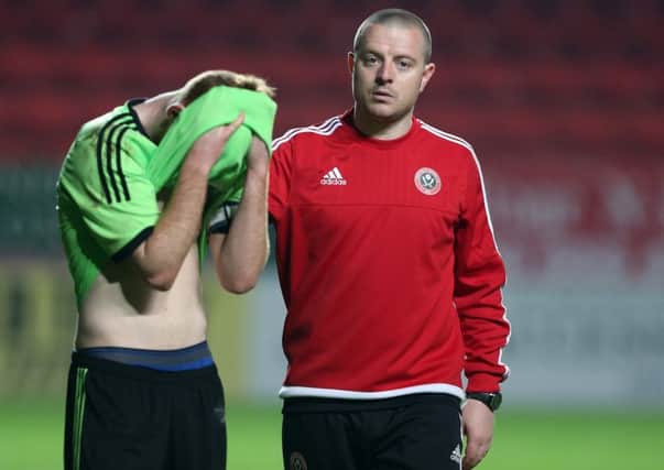 Sheffield United's Travis Binnion consoles Gordon Shea after his penalty miss at the Valley