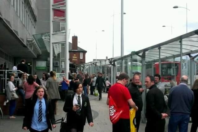 Shoppers gathered outside the centre after the evacuation.