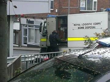 A bomb squad unit prepares for a controlled explosion.