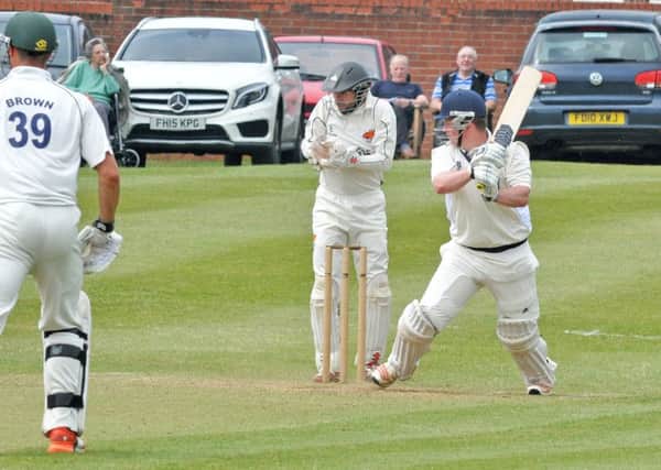 CUTTING LOOSE -- batsman Sam Johnson on his way to a magnificent innings of 118 for champions Kimberley in the big Notts Premier League clash of the weekend against Cuckney, who battled back to salvage a losing draw from a match laced with more than 550 runs.