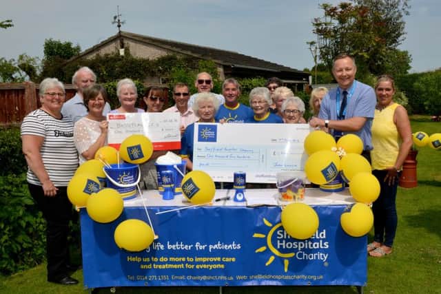Fundraiser Joan Linacre presents cheques to David Reynolds of Sheffield Hospitals Charity and Bassetlaw CCU ward manager Kathy Dykes and Sister Michelle Smith
