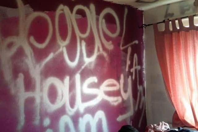 Graffiti sprawled on the walls of the property. Pink paint was also thrown over a Jack Russell dog.