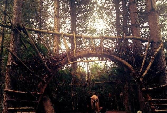 The elaborate camp in the Forest was actually built by local teens - pictured is Michaela White after it was initially constructed.