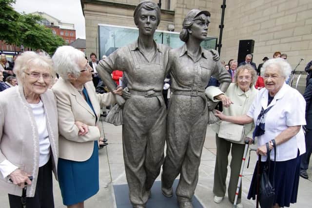 Women Of Steel survivors with their statue in Barker's Pool outside Sheffield City Hall