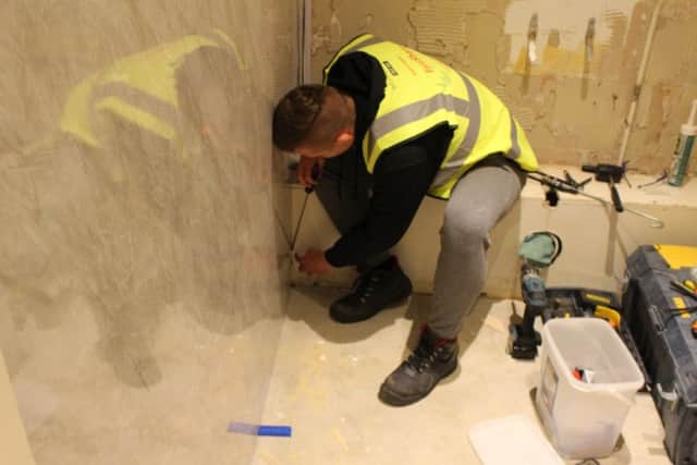 Dinnington High School student Bailey Pearson working on the toilet refurbishment project at Dinington Resource Centre