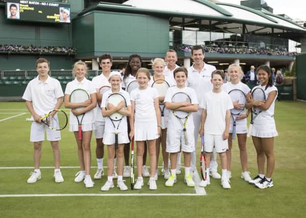 Bradley Buckland (second row, third in from left) with junior players and Tim Henman. Photo credit: onEdition.
