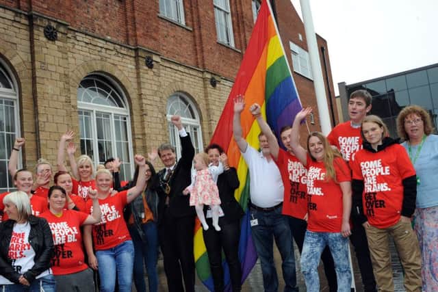 Supporter join Bassetlaw District Council chairman, Coun. Jim Anderson and Worksop Pride organiser, Crystal Lucas pictured at the LGBT flag raising ceremony in Worksop on Wednesday.