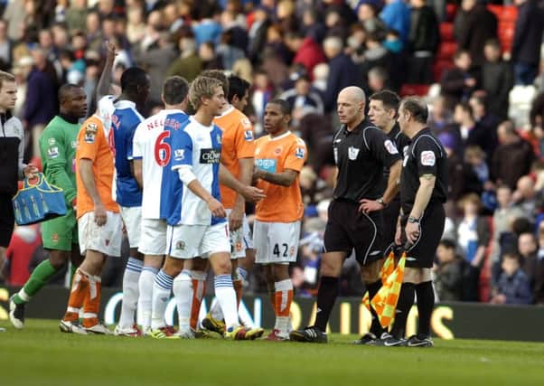 Blackburn Rovers v Blackpool - Football.  Players surround referee Howard Webb at the final whistle.