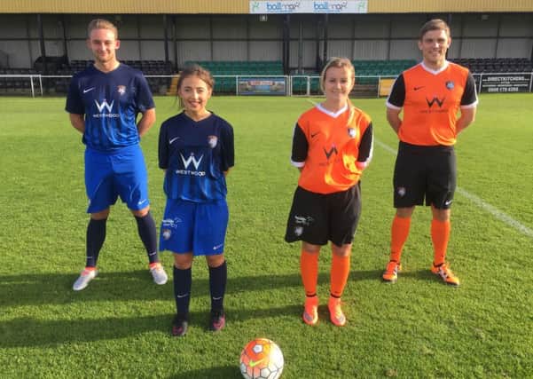 Worksop Town first team and ladies team players show off the new kits