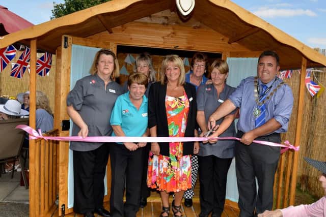 Garden party to celebrate the opening of Foxby Court Care HomeÃ¢Â¬"s new garden and summer house. Gainsborough Mayor Coun Ken Woolley cuts the ribbon with home manager Tracy Turfrey and staff