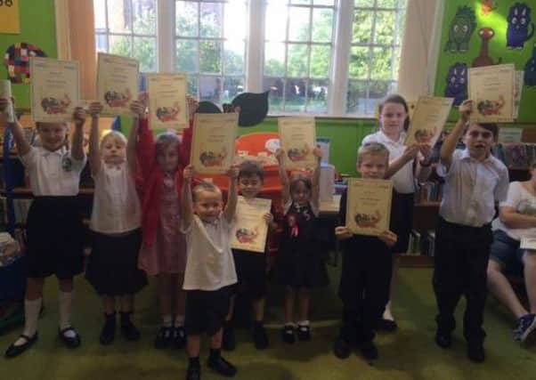 Children celebrate completing the summer reading challenge