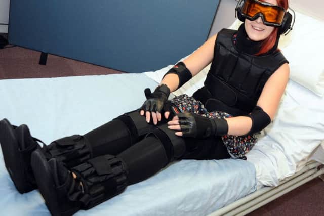 Standard reporter, Shelley Marriot tries to move around with her age simulation suit on.