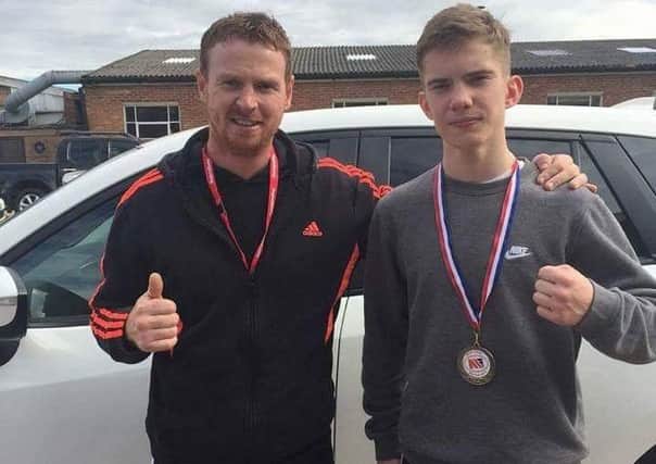 PACKING A PUNCH -- England Box Cup champion Marcus Ellis (right) with his coach at Huthwaite Amateur Boxing Club, Chris Jowett.