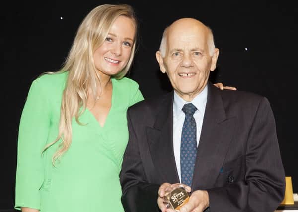 Pictured is Barrie Smith with Hollie Dawson, from award sponsors Holt Doctors.