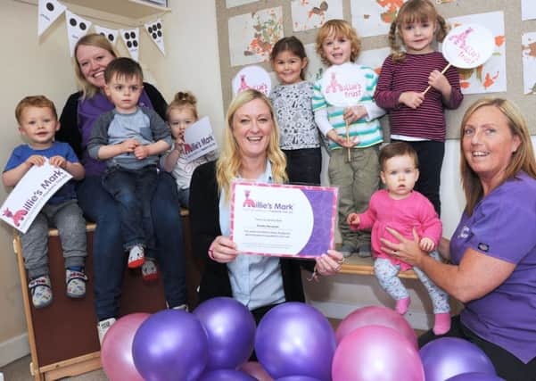 Nursery manager, Jacqui Hannaby, centre, with her deputies, Avril Lee, right and Amy Graney and some of the children who attend the ursery after receiving the Millie's Mark award.